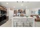Kitchen island with quartz countertops, stainless steel appliances, and three barstools at 4533 Eternal Prince Dr, Sun City Center, FL 33573