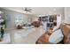 Spacious open-concept living room with tile floors, modern furnishings, and a view to the kitchen at 4533 Eternal Prince Dr, Sun City Center, FL 33573