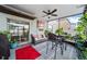 Relaxing screened-in patio with comfy furniture, ceiling fan, decor and views at 4533 Eternal Prince Dr, Sun City Center, FL 33573