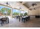 Spacious outdoor community patio with ceiling fans, tables, chairs, and a functional countertop bar area at 4533 Eternal Prince Dr, Sun City Center, FL 33573
