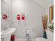 Neutral powder room with a pedestal sink and decorative accents at 4533 Eternal Prince Dr, Sun City Center, FL 33573