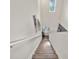Bright stairway features wood stairs, a tall ceiling, and modern wall decor leading to the front door at 4533 Eternal Prince Dr, Sun City Center, FL 33573