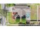 Overhead view showcasing a home's backyard pool, well-maintained roof, landscaping, and neighborhood streets at 4708 Ranch Grove Ct, Valrico, FL 33596