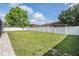 Expansive backyard enclosed by a white fence, providing privacy and ample space for recreation and relaxation at 4708 Ranch Grove Ct, Valrico, FL 33596