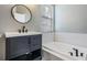 Bathroom features a vanity with black fixtures, decorative tile floors, and a soaking tub with subway tile surround at 4708 Ranch Grove Ct, Valrico, FL 33596