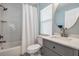 Bright bathroom featuring subway tile, a shower-tub combo, and a modern vanity with a round mirror at 4708 Ranch Grove Ct, Valrico, FL 33596