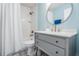 Bathroom features subway tile, shower-tub, and a modern vanity with round mirror at 4708 Ranch Grove Ct, Valrico, FL 33596