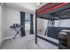 Bedroom featuring a black loft bed with dark curtains, a keyboard and a large window at 4708 Ranch Grove Ct, Valrico, FL 33596