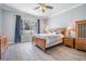 Comfortable bedroom features wood-look tile floors, crown molding, a large window and classic wood furniture at 4708 Ranch Grove Ct, Valrico, FL 33596