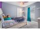Cozy bedroom with playful decor featuring blue accents and a comfortable twin bed with storage drawers at 4708 Ranch Grove Ct, Valrico, FL 33596