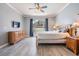 Spacious bedroom featuring wood-look tile floors, crown molding, a large window and classic wood furniture at 4708 Ranch Grove Ct, Valrico, FL 33596