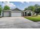Charming single-story home with a well-manicured lawn and a three-car garage at 4708 Ranch Grove Ct, Valrico, FL 33596