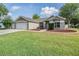 Charming single-story home with a well-manicured lawn and a three-car garage at 4708 Ranch Grove Ct, Valrico, FL 33596