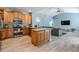 Open-concept kitchen with stainless steel appliances and breakfast bar overlooking the living area at 4708 Ranch Grove Ct, Valrico, FL 33596