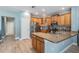 Contemporary kitchen featuring wood cabinetry, stainless steel appliances, granite counters, and an inviting breakfast bar area at 4708 Ranch Grove Ct, Valrico, FL 33596
