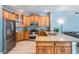 Stylish kitchen with wood cabinetry, granite countertops, stainless appliances, and tile flooring, offering a modern and inviting space at 4708 Ranch Grove Ct, Valrico, FL 33596