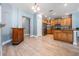 Inviting open-concept layout connecting the dining area to the kitchen with wood cabinets, granite countertops, and modern appliances at 4708 Ranch Grove Ct, Valrico, FL 33596