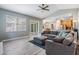 Open-concept living area with tile flooring, modern furnishings, and easy access to the kitchen, creating a welcoming ambiance at 4708 Ranch Grove Ct, Valrico, FL 33596
