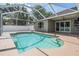 Backyard oasis featuring a sparkling pool with volleyball net within a screened enclosure at 4708 Ranch Grove Ct, Valrico, FL 33596