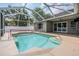 Enjoy the beautiful pool with volleyball net inside the screened enclosure at 4708 Ranch Grove Ct, Valrico, FL 33596