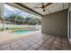 Enjoy a refreshing pool with volleyball net in a screened-in enclosure for outdoor relaxation and fun at 4708 Ranch Grove Ct, Valrico, FL 33596