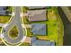 An aerial view shows a modern home with a gray roof, green lawn, and cul-de-sac street in a residential community at 4831 Rosatti Rd, Wesley Chapel, FL 33543