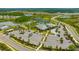 Aerial view shows a community clubhouse with pool, tennis courts, parking, and landscaped grounds at 4831 Rosatti Rd, Wesley Chapel, FL 33543