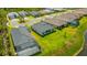 An aerial view shows a home with screened lanai and green lawn backing up to a pond in a residential community at 4831 Rosatti Rd, Wesley Chapel, FL 33543