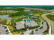 Aerial view of the community clubhouse with a pool, tennis courts, and beautifully landscaped grounds at 4831 Rosatti Rd, Wesley Chapel, FL 33543