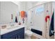 Colorful bathroom with modern fixtures, and a playful art-deco design on the shower curtain at 4831 Rosatti Rd, Wesley Chapel, FL 33543