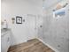 Modern bathroom features tile floors, walk-in shower, and door at 4831 Rosatti Rd, Wesley Chapel, FL 33543