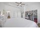 Bright bedroom offering wood flooring and white decorative storage shelves for books or linens at 4831 Rosatti Rd, Wesley Chapel, FL 33543