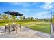 Enjoy a friendly game of bocce ball in this beautifully landscaped recreation area with an umbrella-shaded table at 4831 Rosatti Rd, Wesley Chapel, FL 33543