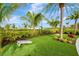 An open green lawn with manicured landscaping and a cornhole game, perfect for outdoor activities and gatherings at 4831 Rosatti Rd, Wesley Chapel, FL 33543