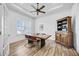 Bright dining room featuring natural light, modern ceiling fan, shuttered windows and rustic wooden table at 4831 Rosatti Rd, Wesley Chapel, FL 33543
