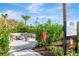 An outdoor fireside seating area surrounded by lush landscaping, offering a cozy and inviting space at 4831 Rosatti Rd, Wesley Chapel, FL 33543