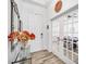Bright foyer with decorative mirror, console table with flowers, and view into dining room through French doors at 4831 Rosatti Rd, Wesley Chapel, FL 33543