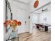 Bright foyer with decorative mirror, console table with flowers, and view into dining room through French doors at 4831 Rosatti Rd, Wesley Chapel, FL 33543