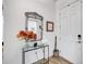 Welcoming foyer with decorative mirror, stylish console table with flowers, and attractive tile flooring at 4831 Rosatti Rd, Wesley Chapel, FL 33543