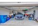 Garage with a car, epoxy floors, storage, and good lighting at 4831 Rosatti Rd, Wesley Chapel, FL 33543