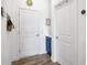 Hallway featuring white walls, wood-look flooring, a blue vanity, and white doors at 4831 Rosatti Rd, Wesley Chapel, FL 33543