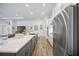 Bright kitchen featuring stainless steel appliances, white countertops and wood-look tile flooring at 4831 Rosatti Rd, Wesley Chapel, FL 33543