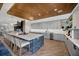 Island with seating and stone accents complemented by pendant lighting at 4831 Rosatti Rd, Wesley Chapel, FL 33543