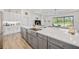 Spacious kitchen island with a large sink, stainless steel appliances, and a view to the living room at 4831 Rosatti Rd, Wesley Chapel, FL 33543