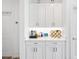 Kitchenette featuring white cabinets, stainless steel appliances, and a wine rack at 4831 Rosatti Rd, Wesley Chapel, FL 33543