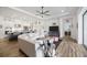 Open-concept living room featuring hardwood floors, a modern ceiling fan, and a view into the kitchen at 4831 Rosatti Rd, Wesley Chapel, FL 33543
