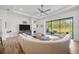 Bright living room featuring a large sectional sofa and sliding glass doors to the backyard at 4831 Rosatti Rd, Wesley Chapel, FL 33543