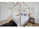 Main bedroom featuring a four-poster bed, light-colored walls and access to the en-suite bathroom at 4831 Rosatti Rd, Wesley Chapel, FL 33543
