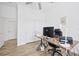 A home office with a modern desk, office chair, and wood-look floors at 4831 Rosatti Rd, Wesley Chapel, FL 33543