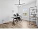 Bright office space with wood-look tile, ceiling fan, and desk by a window at 4831 Rosatti Rd, Wesley Chapel, FL 33543